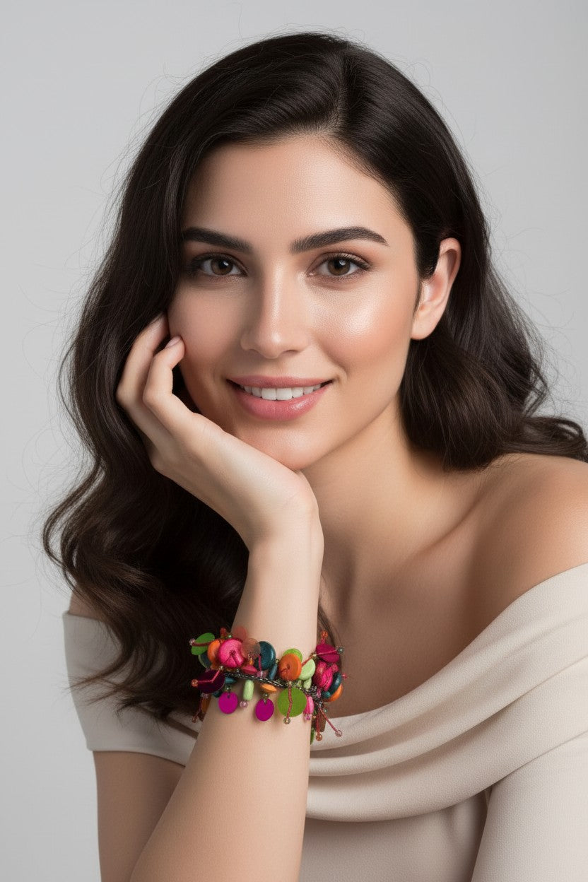 woman wearing Multi-strand bohemian bracelet featuring cascading colorful disc charms and tropical bead accents in lime green, orange, and teal.