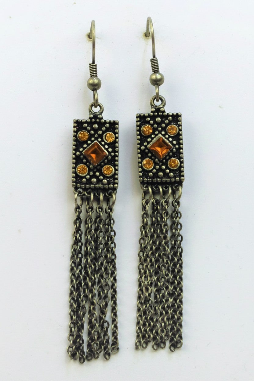 Pair of antique bronze drop earrings featuring a textured rectangular pendant set with warm topaz amber crystals and fine chain tassels.