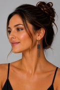 Pair of antique bronze drop earrings featuring a textured rectangular pendant set with vibrant blue crystals and cascading fine chain tassels.