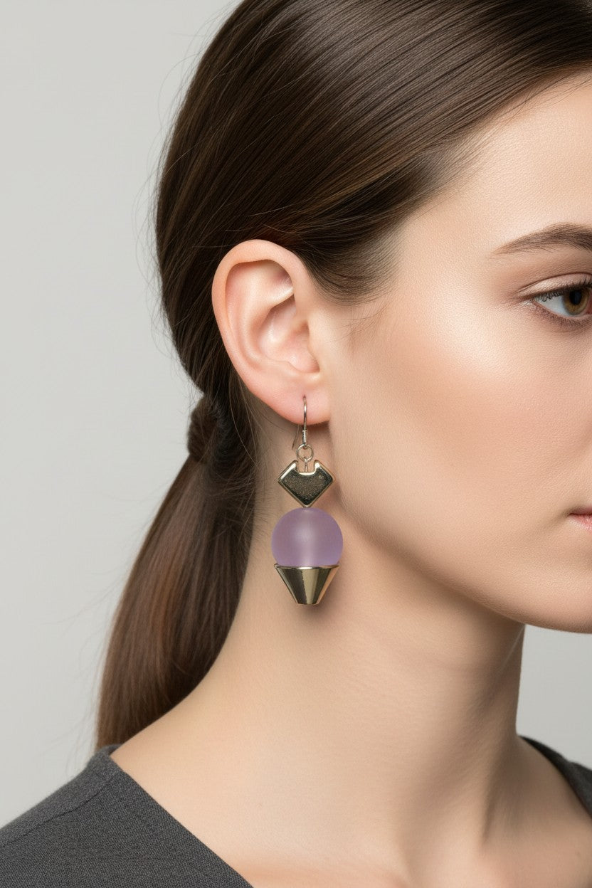  Side profile view of a model wearing a pair of Australian Made silver plated drop earrings with a smooth matte lilac ball charm.