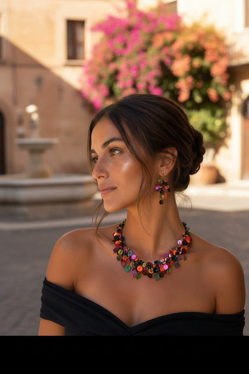 woman  in Italy wearing multi-colored necklace and earrings. stylish coin charm jewelry set 