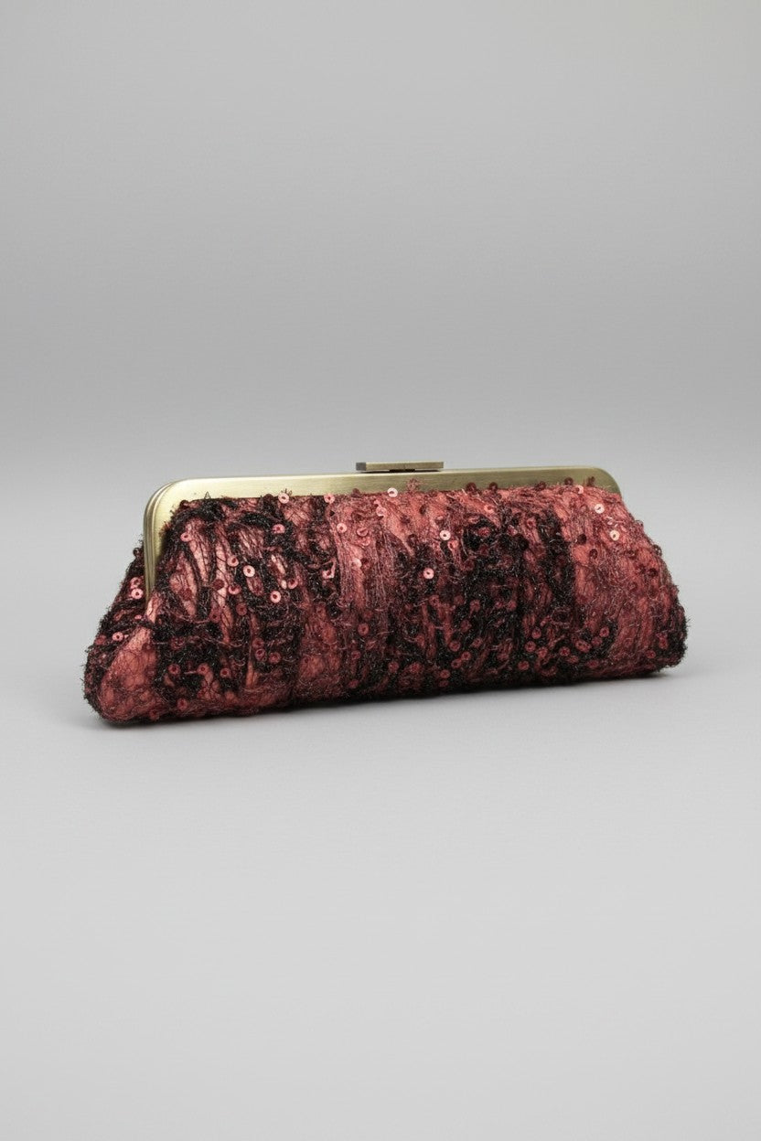 A bronze sequined clutch purse with a gold-tone metal frame closure, photographed on a neutral gray background.