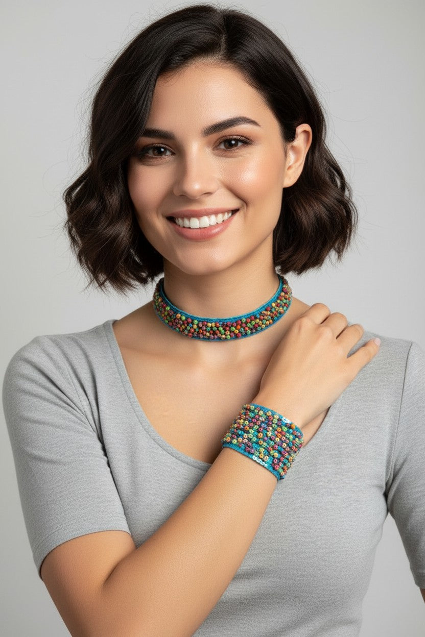 Woman smiling while wearing a matching bohemian jewelry set featuring a wide turquoise woven choker necklace and thick cuff bracelet embroidered with vibrant multicolored seed beads.