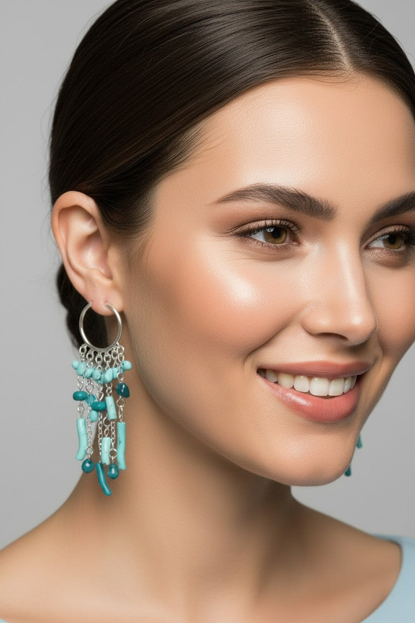 Turquoise beaded chandelier hoop earrings featuring cascading aqua and teal stone-shaped beads on delicate silver chains.